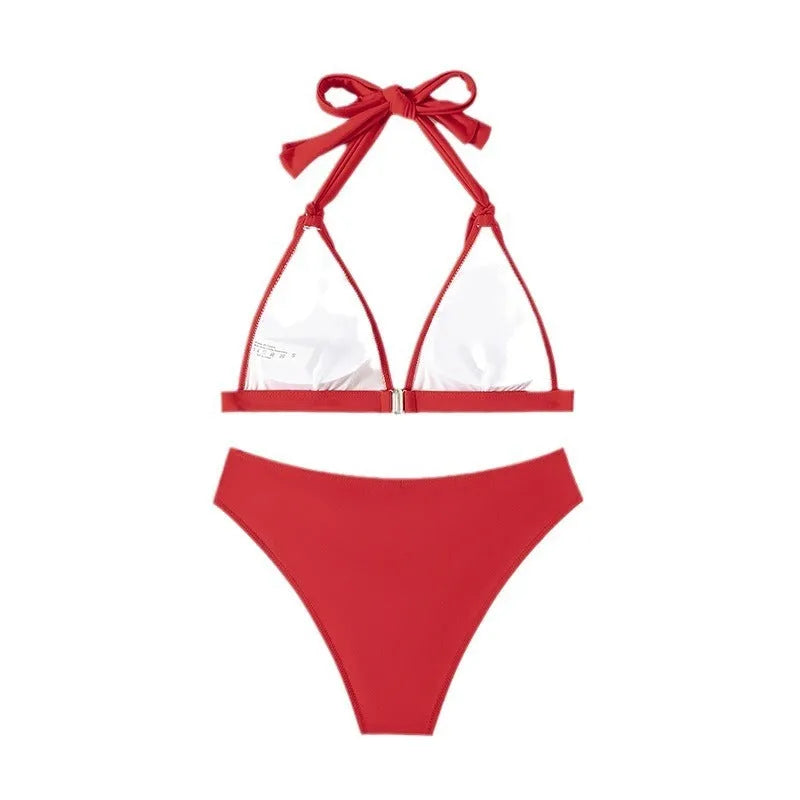 Red women's halterneck bikini with lace-up front closure and split-leg shorts
