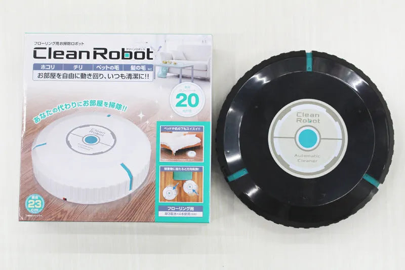 Black or white automatic sweeping robot on a wooden floor, showing compact square design.