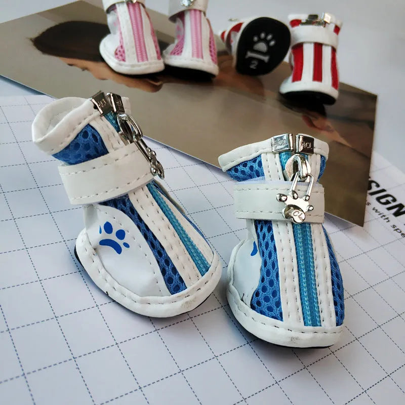 Set of four blue cloth dog shoes with zippers, designed for small breed pets on a white background.