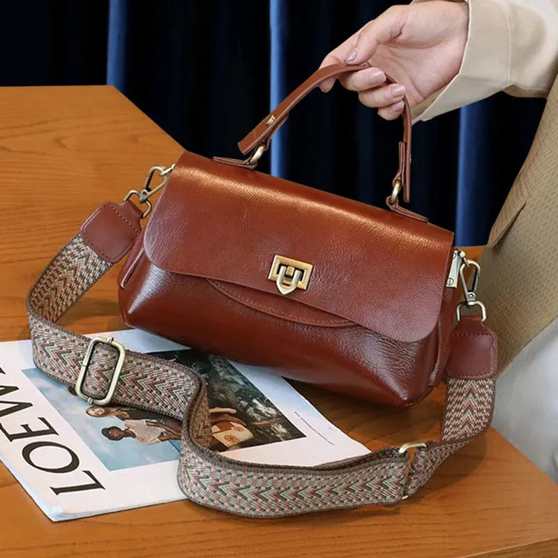 A dark brown women's leather saddle handbag with visible stitching and an open front pocket.