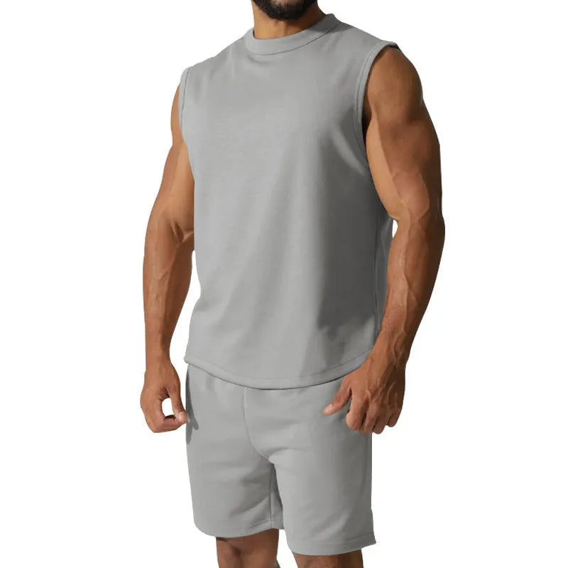 Men's sleeveless cotton blend sports top and matching shorts set in a solid colour.