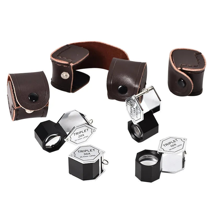 Handheld metal portable magnifying glass for jewellery and coin inspection with optical glass lenses.