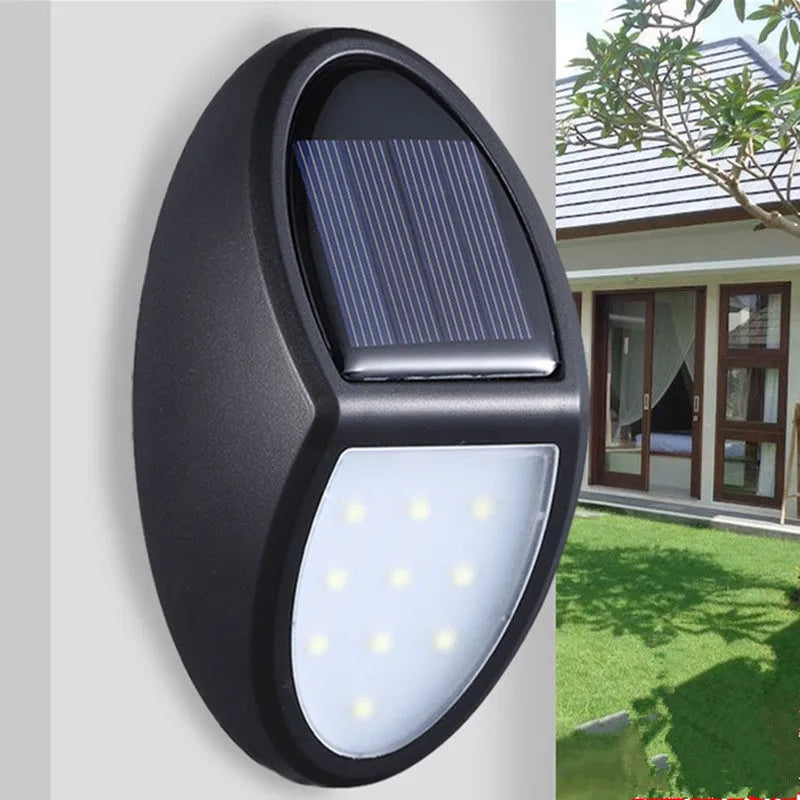 Black solar-powered wall light with solar panel and LED illumination