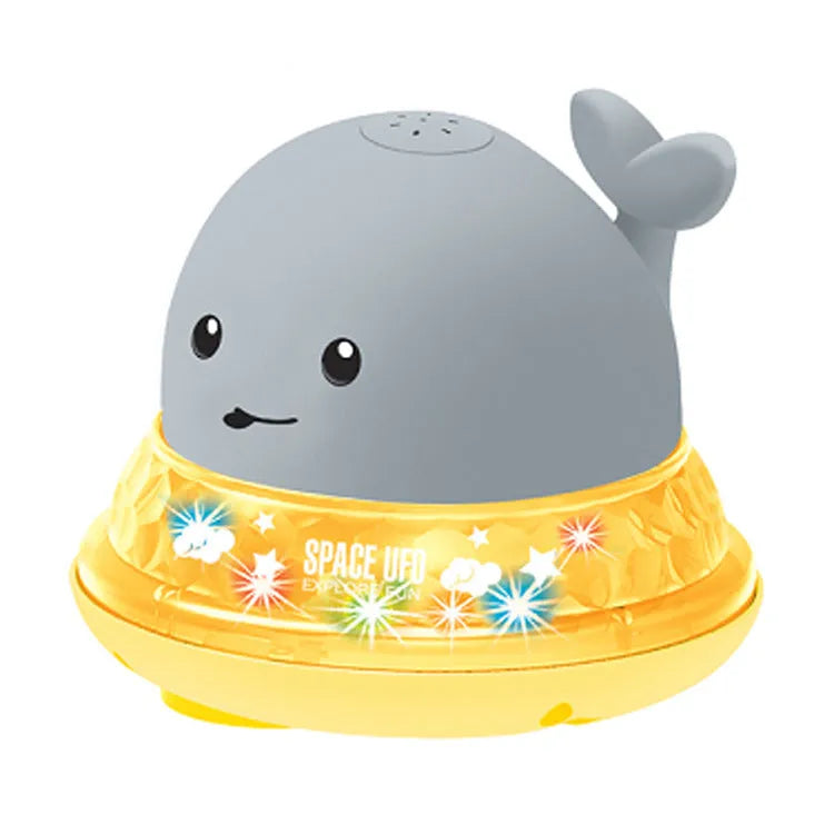 Automatic spray whale baby bath toy with LED lights on a blue base
