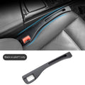 Black plastic car seat gap storage box with handle between vehicle seats