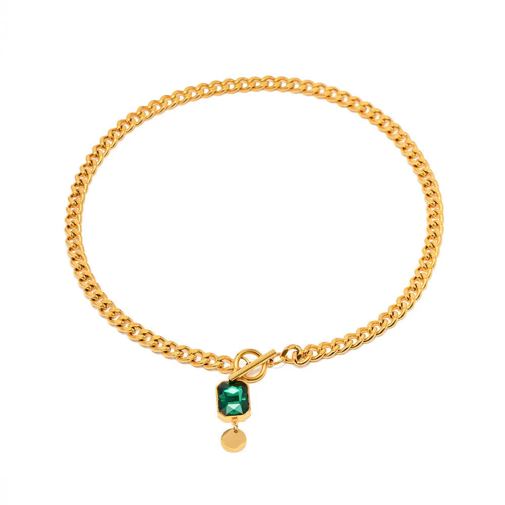 Gold tone geometric pendant necklace with emerald green zircon stone on Cuban link chain