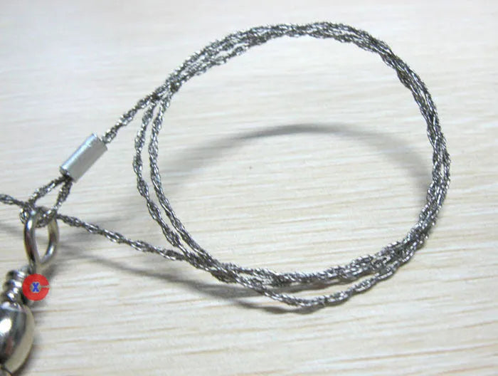 Survival wire saw with thumb rings extended to 70cm total length on a background.