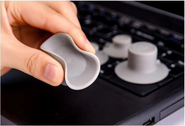 Two large and two small grey plastic laptop cooling pads on a flat surface.