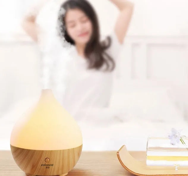 Wood grain finish vase-shaped aroma diffuser with 100ml water tank capacity.