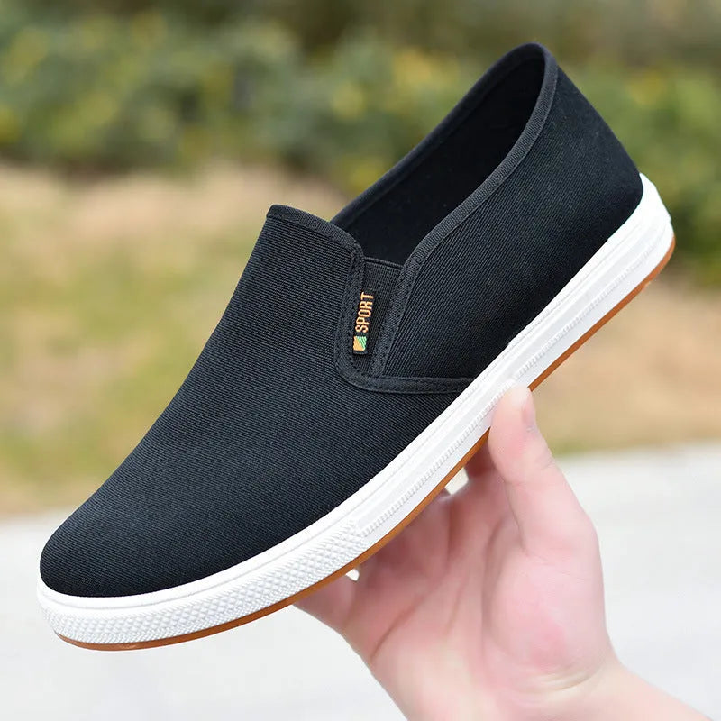 Men's black and blue low-top canvas slip-on shoes with round toe and composite soles