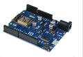 Black WiFi development board with ESP-8266EX chip, pin headers, and USB connector.