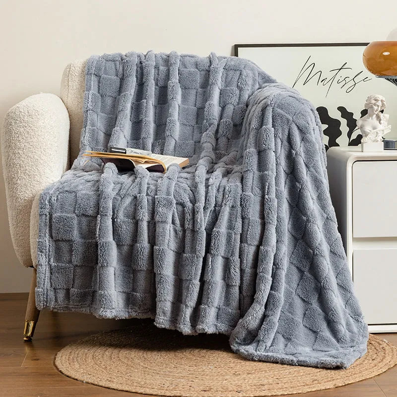 Geometric pattern polyester blanket in milky white colour on grey sofa