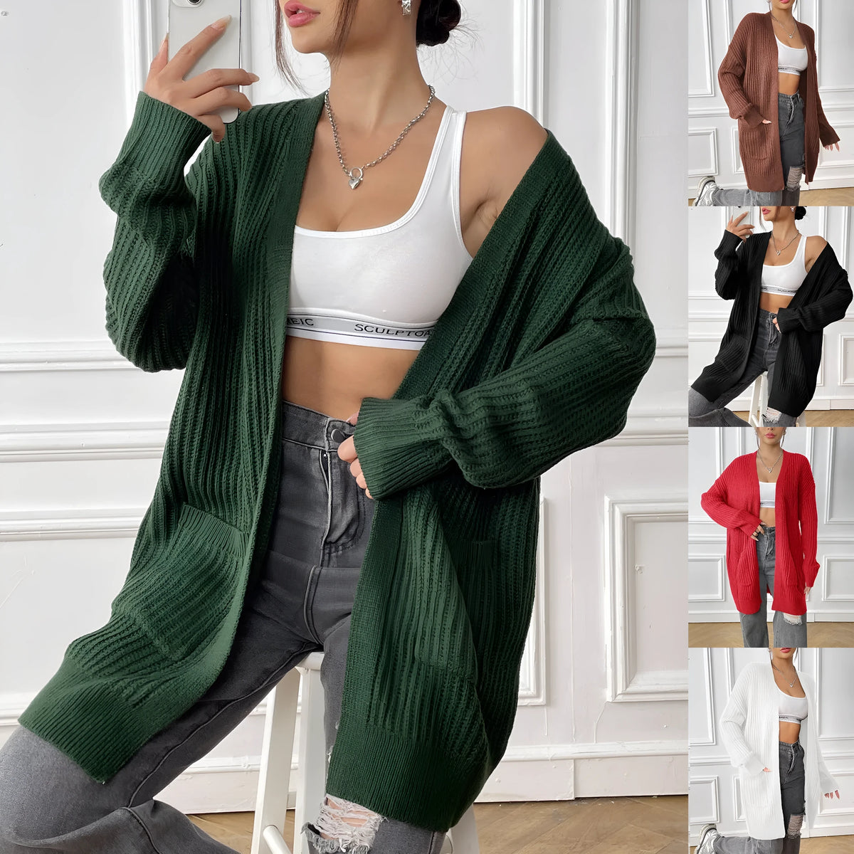 Women's dark green double pocket acrylic cardigan with long sleeves on a hanger.