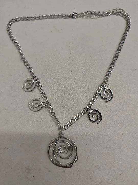 Spiral donut jewellery set with geometric circle designs including adjustable necklace, bracelet and ear hooks