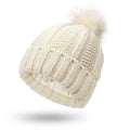 Women's black knit beanie with faux fur pom pom, showing satin lining and Paisley pattern inside.
