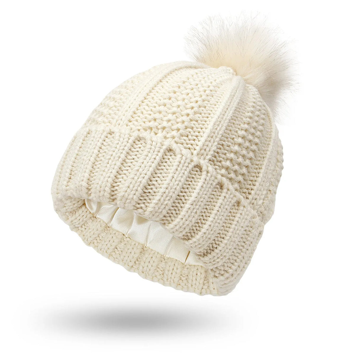 Women's black knit beanie with faux fur pom pom, showing satin lining and Paisley pattern inside.