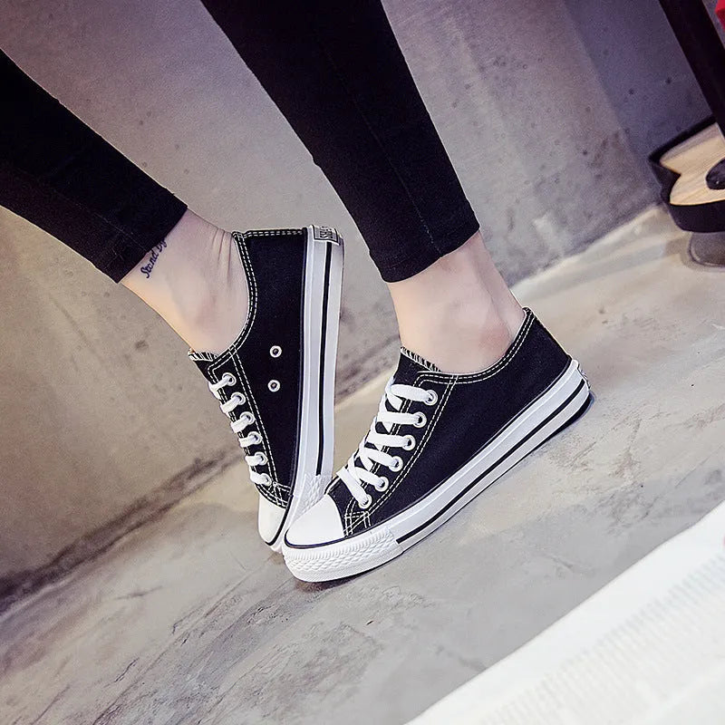 Women's solid-colour canvas lace-up trainers on a white background, showing the casual design and lace detail.