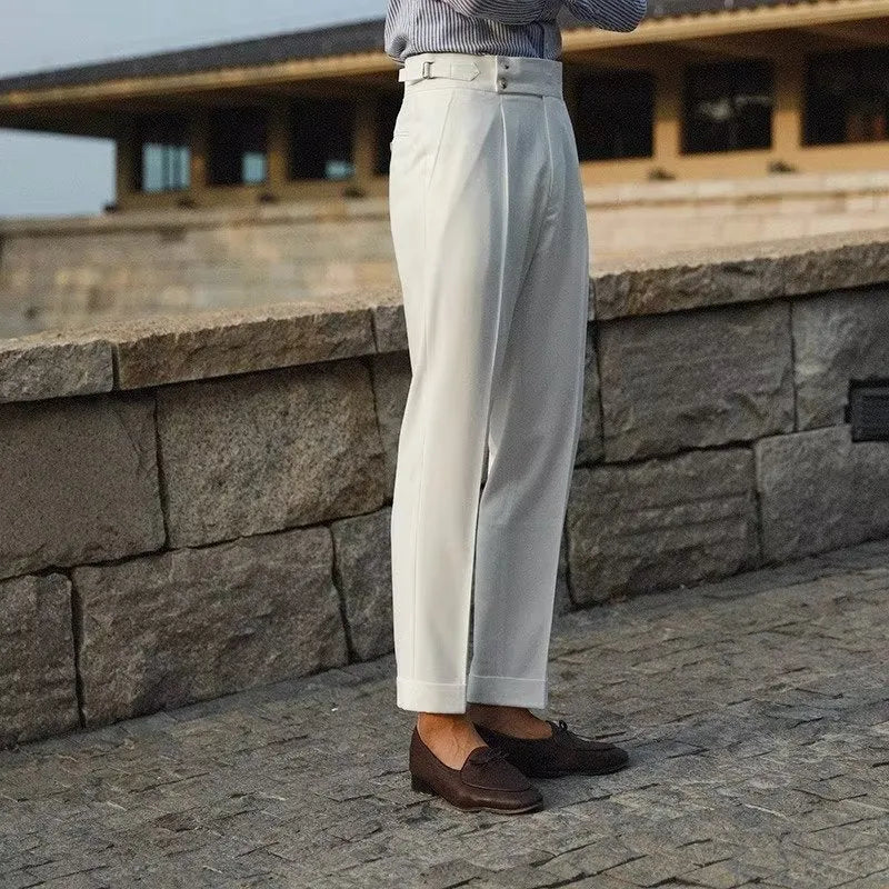 Men's slim fit straight-leg suit trousers in black, white, and apricot colours on a hanger.