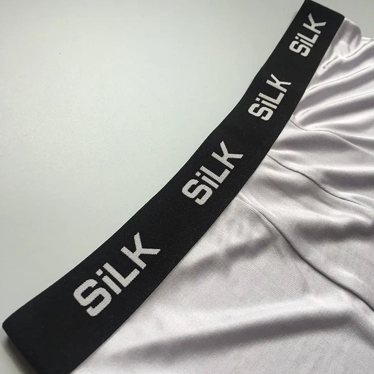 Men's loose silk shorts in navy blue, silver gray, and skin color with mid-waist design