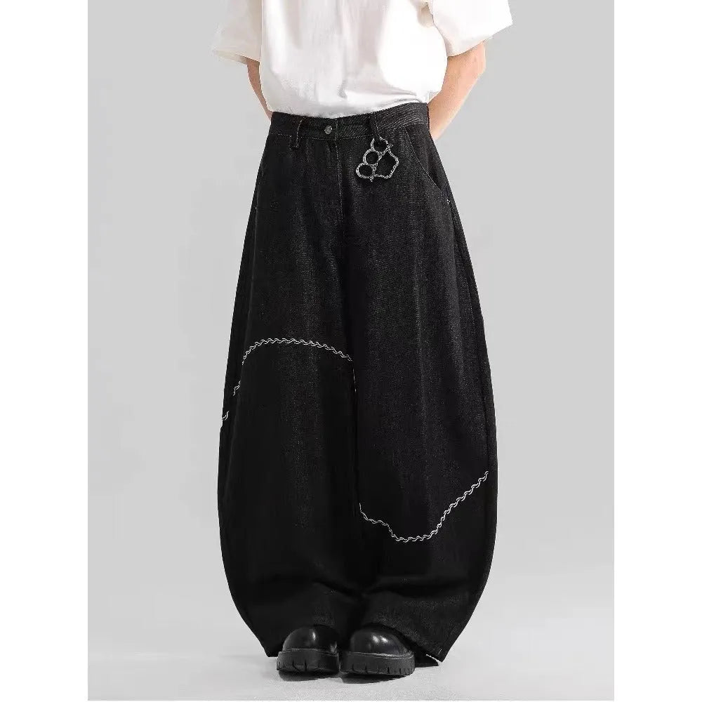 Black straight-leg denim trousers with a mid-waist and zip fly on a plain background.