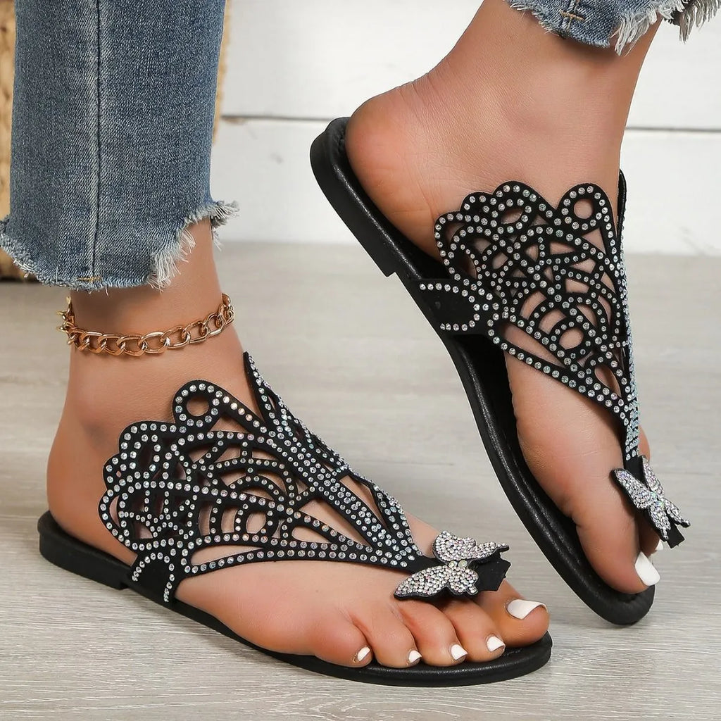 Women's gold slip-on sandals with rhinestone decoration and open flip-toe design.
