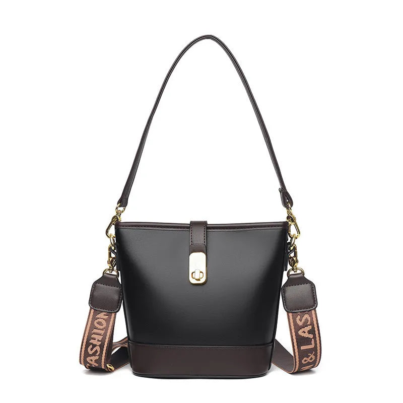 Korean style black bucket messenger bag with double shoulder strap showing zip compartments and urban design details