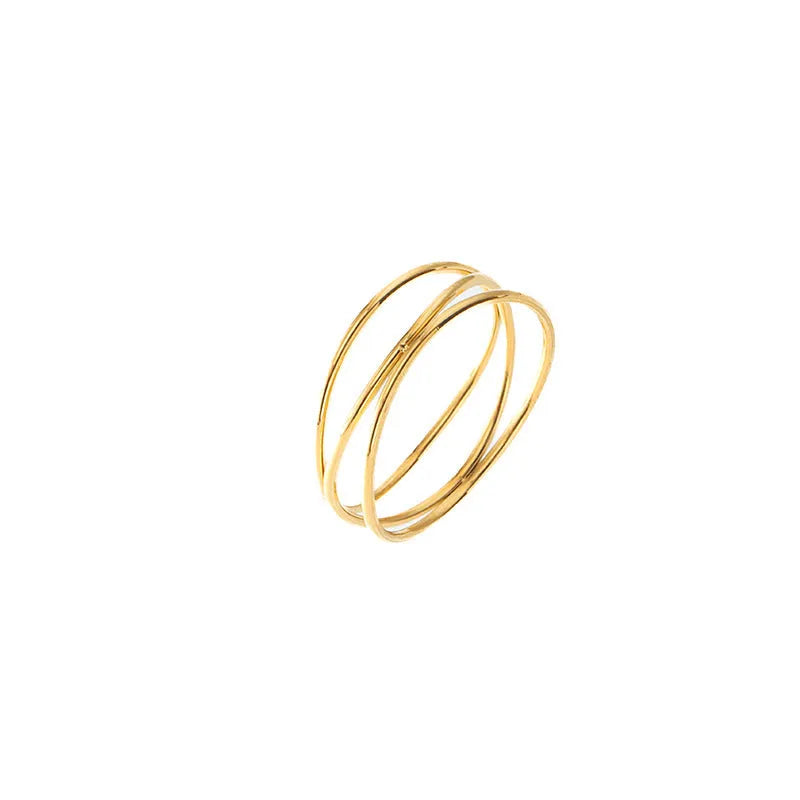 Geometric gold titanium steel coil ring showing three-layer design on a model's finger.