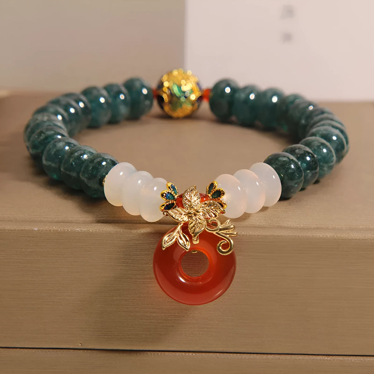 Blue jade and red agate bead bracelet with a crystal peace buckle closure.