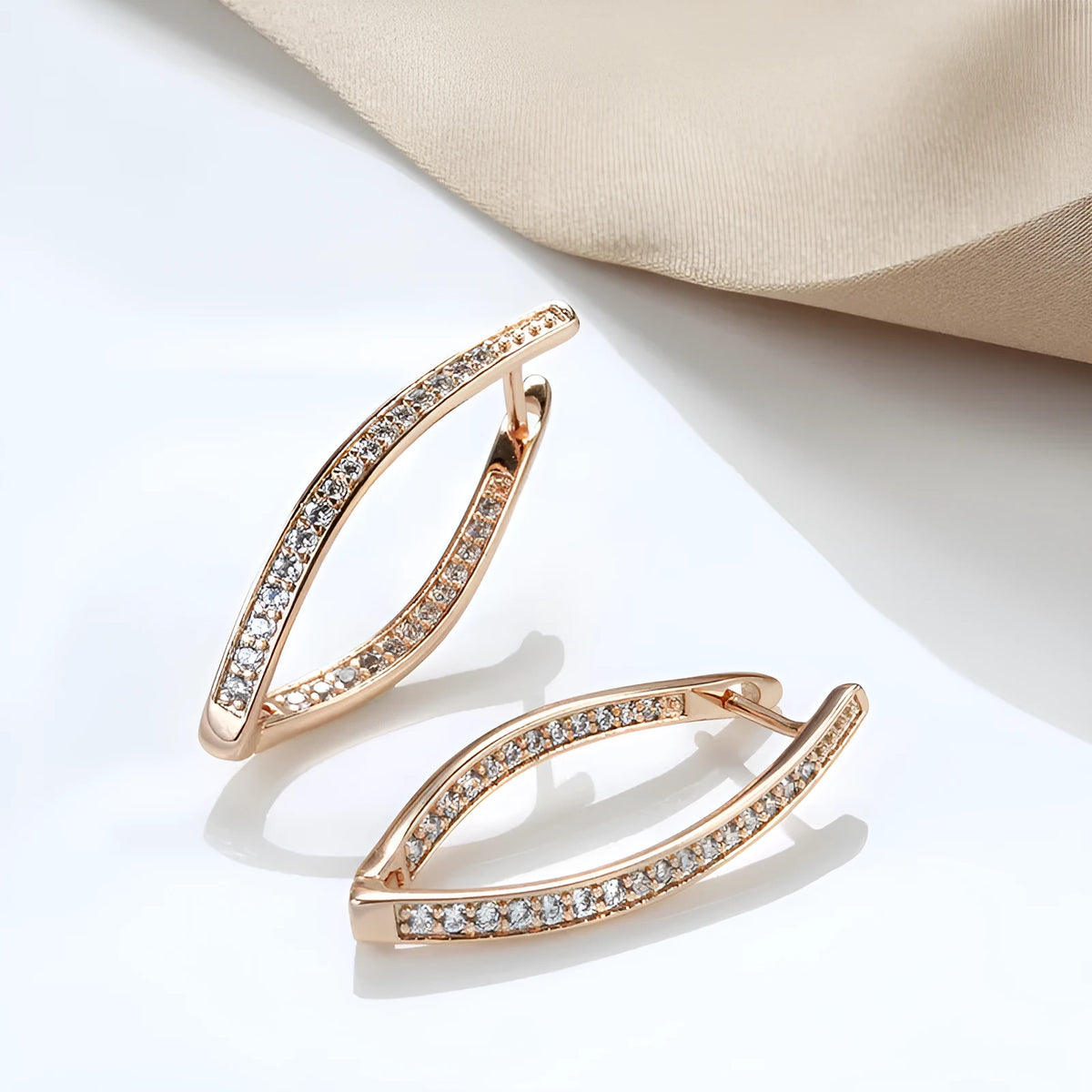 A pair of geometric-shaped copper earrings with zircon detail in H0493 colour, shown from the front.