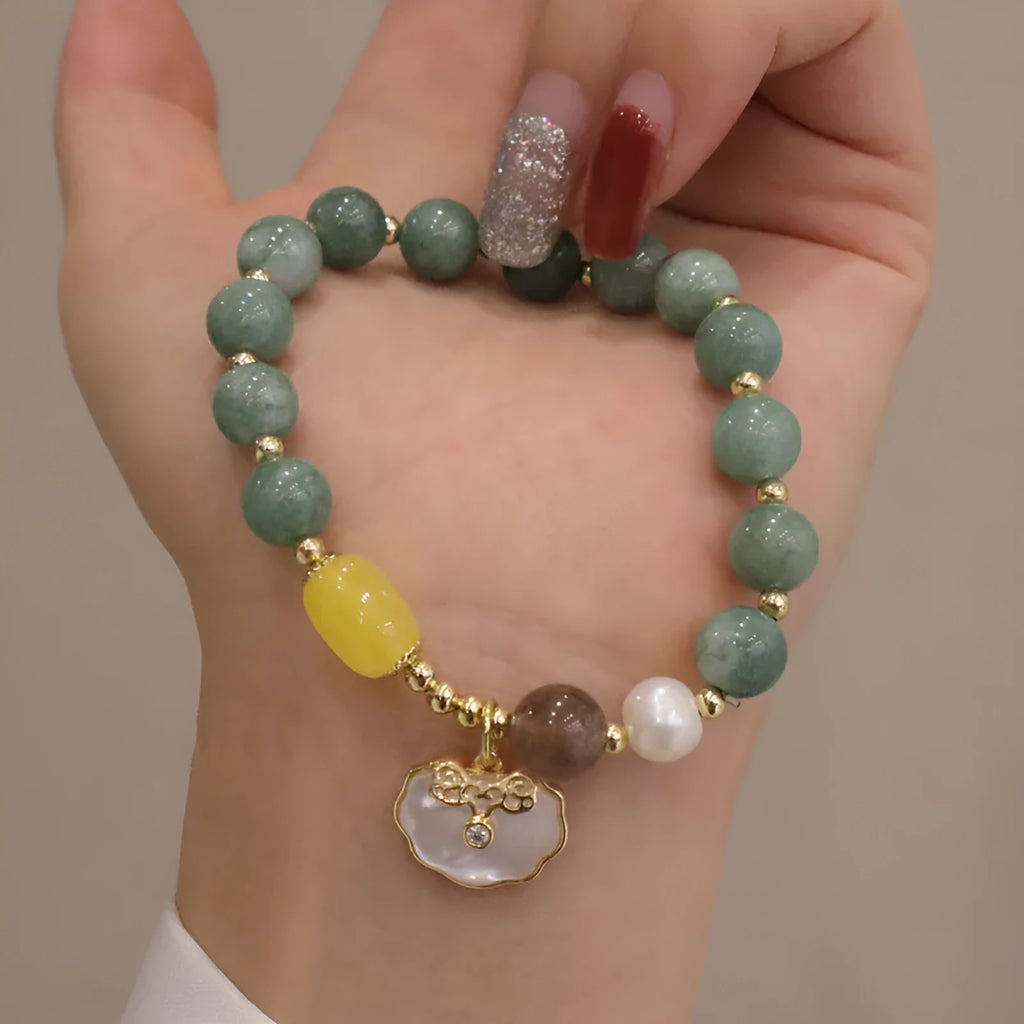 Green jade bracelet with shell pattern beads on an adjustable black cord.