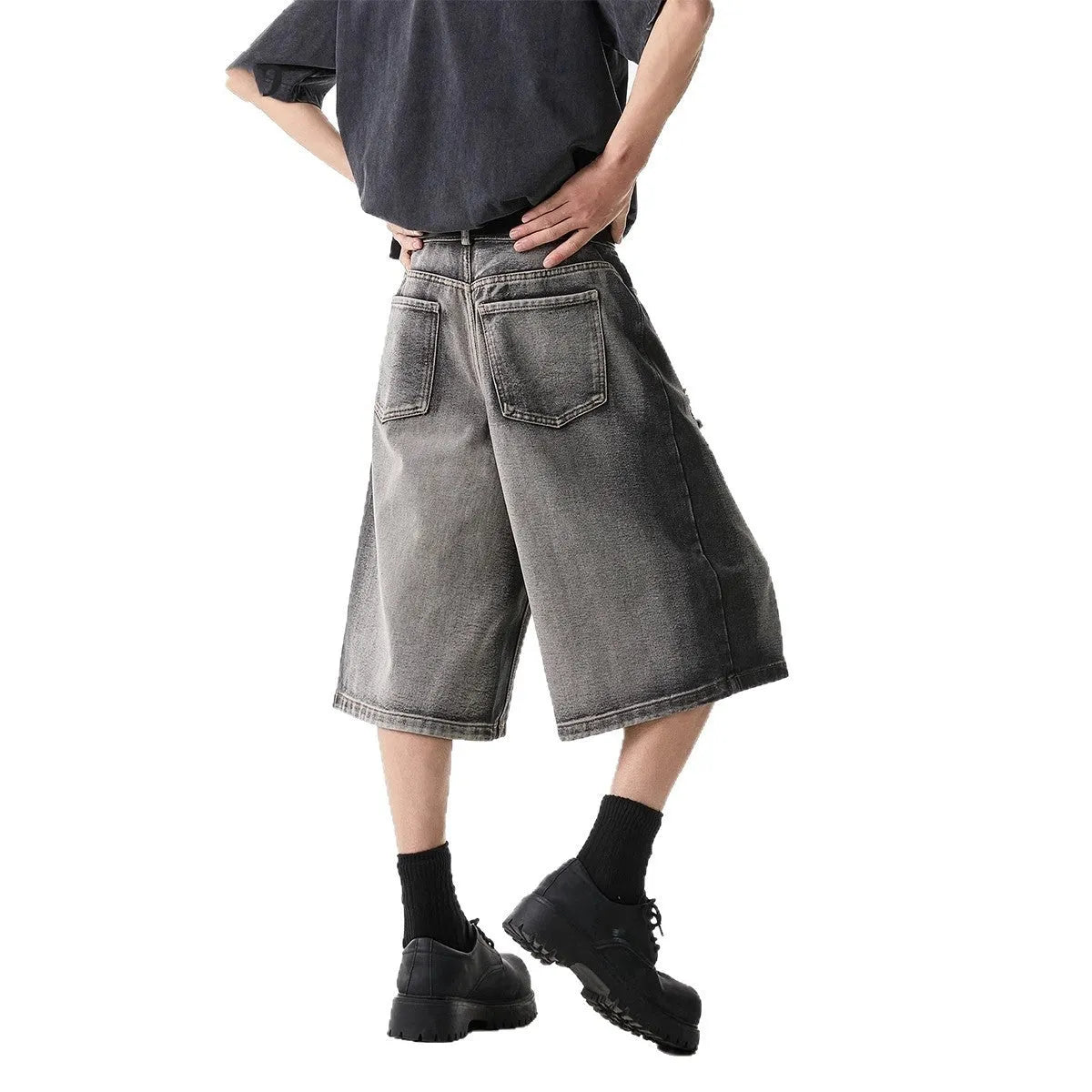 Women's loose-fit washed grey denim shorts with distressed hole details, cropped length.