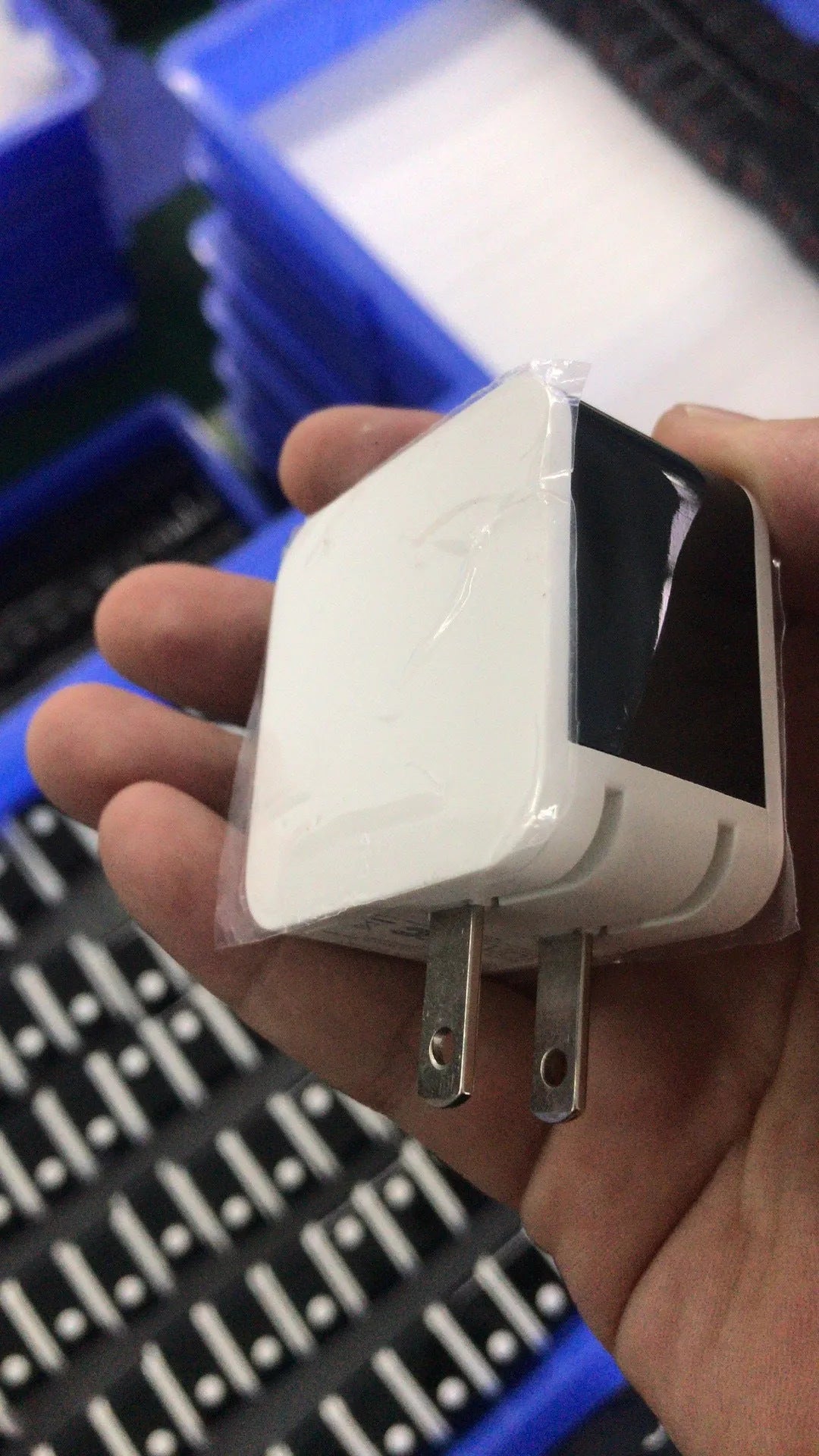 Black dual USB fast travel charger with digital display showing voltage reading and UK three-pin plug