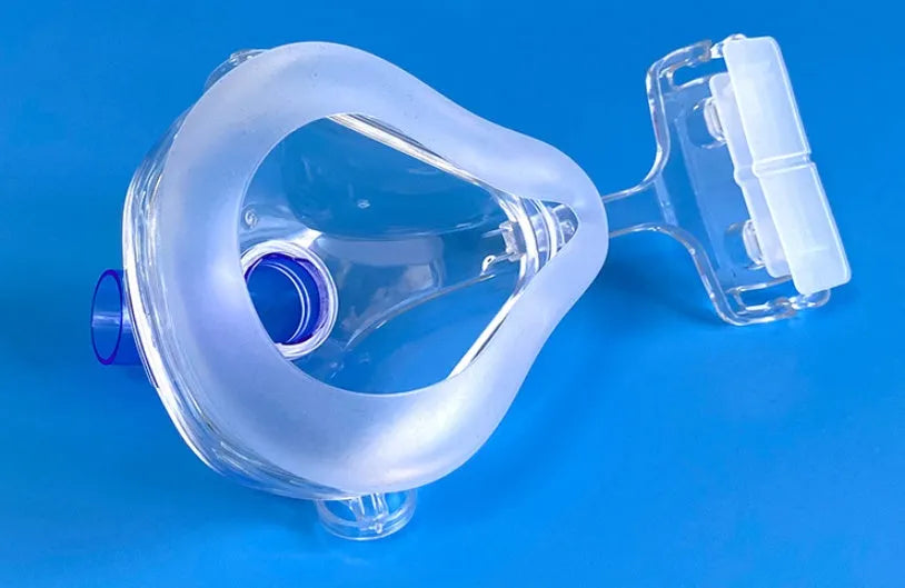 CPAP breathing mask with transparent silicone cushion and polycarbonate frame with ventilator adapter elbows
