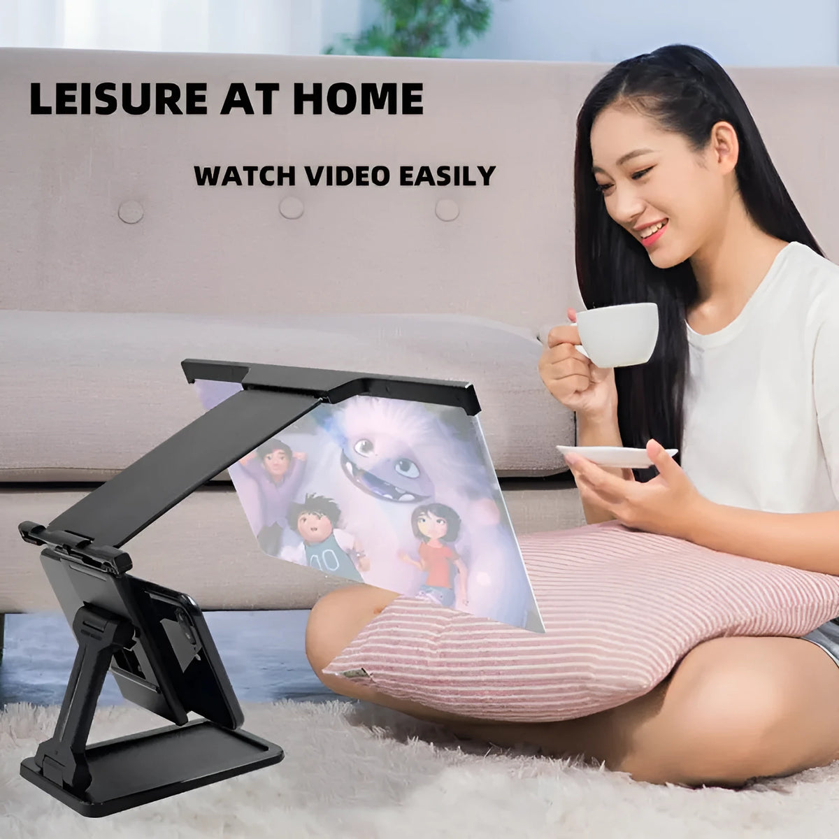 Black folding mobile phone screen amplifier with detachable holder, shown magnifying a smartphone display.