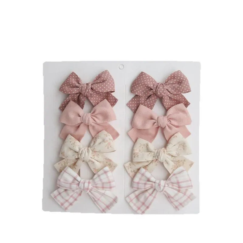 Children's cloth bow hairclips set with dovetail design in multiple colour patterns