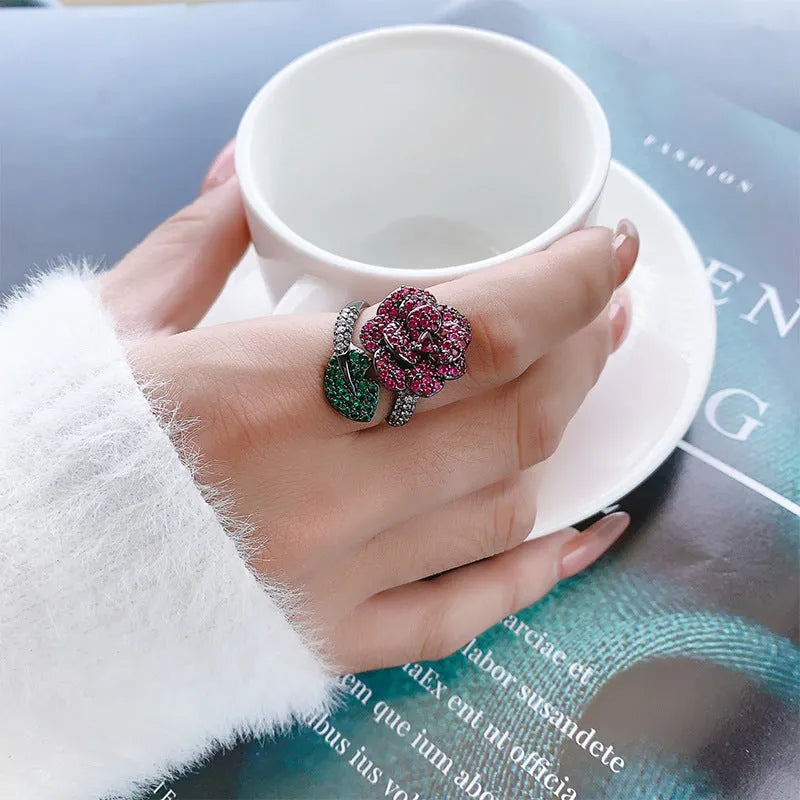 Black gold geometric floral ring with diamond-treated red corundum stone on copper band