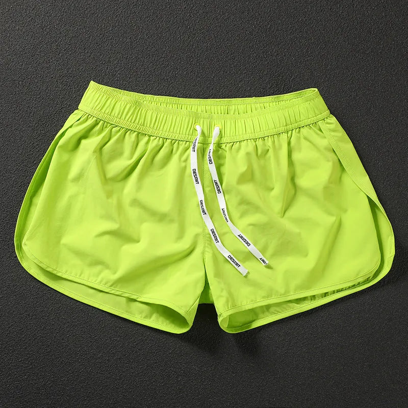 Men's elastic waist beach shorts in black, fluorescent green, or orange red colours for surfing and swimming