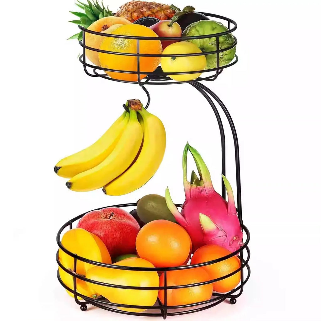 Double-tier black wrought iron fruit basket filled with assorted fruits on a countertop