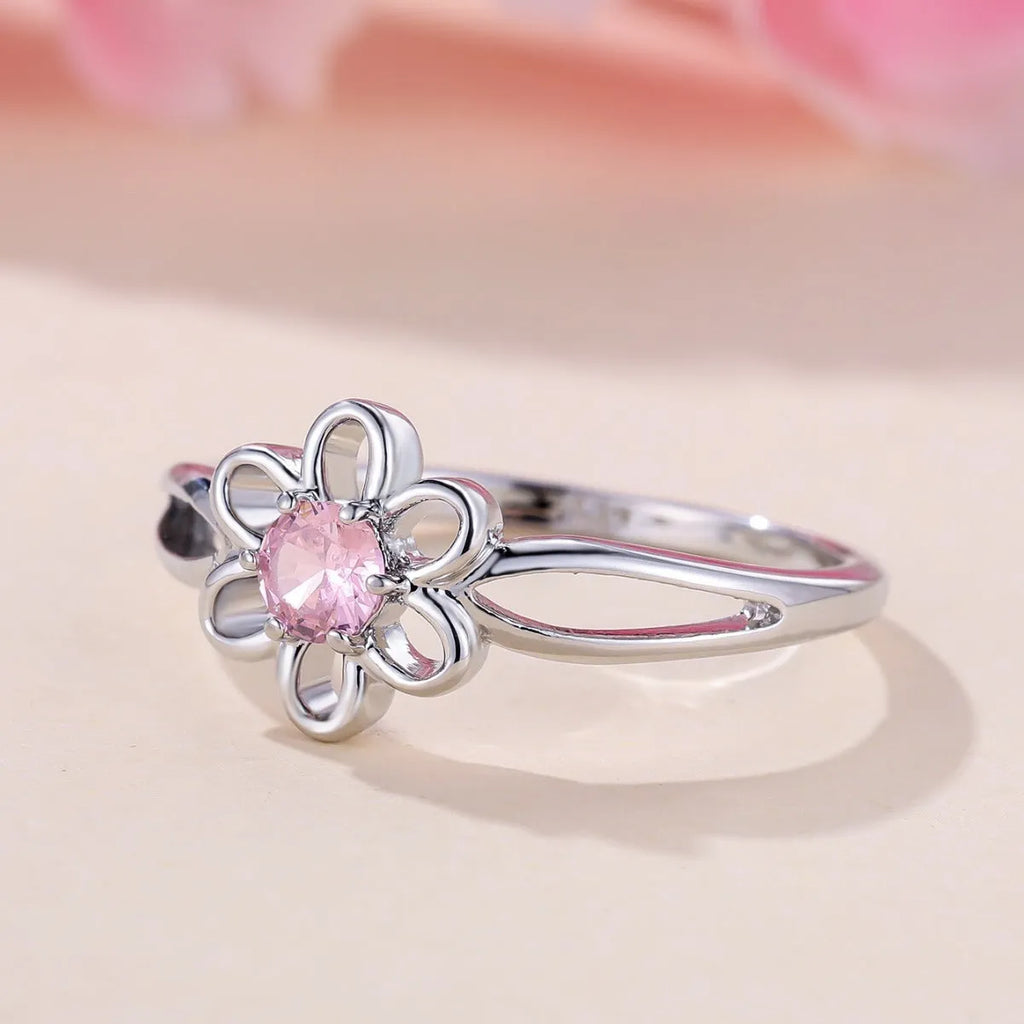 Women's hollowed flower fashion ring in copper with electroplated finish on a size chart.