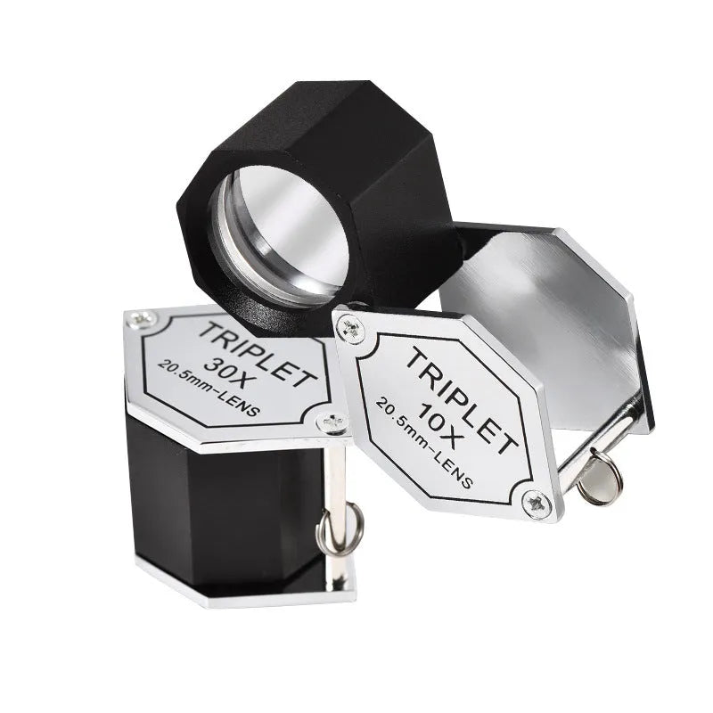 Handheld metal portable magnifying glass for jewellery and coin inspection with optical glass lenses.