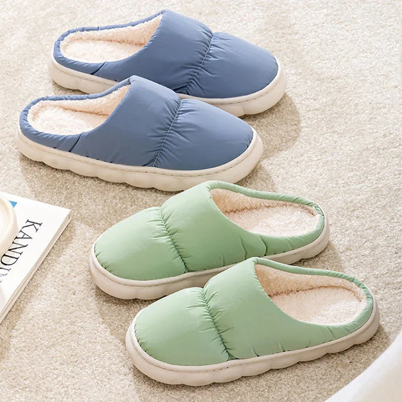 Blue down cotton slippers with a thick rubber sole and plush lining for indoor winter wear.