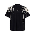 Black short-sleeved t-shirt with padded shoulders and rivet ribbon detail in loose fit round neck style
