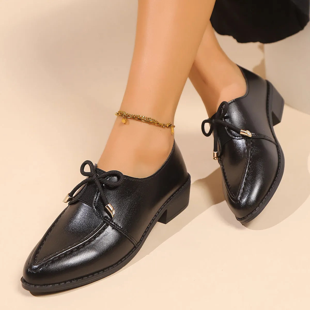 Women's British-style flat shoes with bow detail, pointed toe, and rubber sole