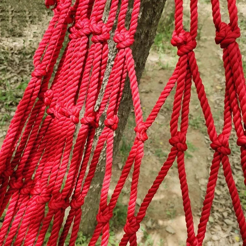 Nylon rope mesh outdoor hammock showing bold pattern construction with tying equipment