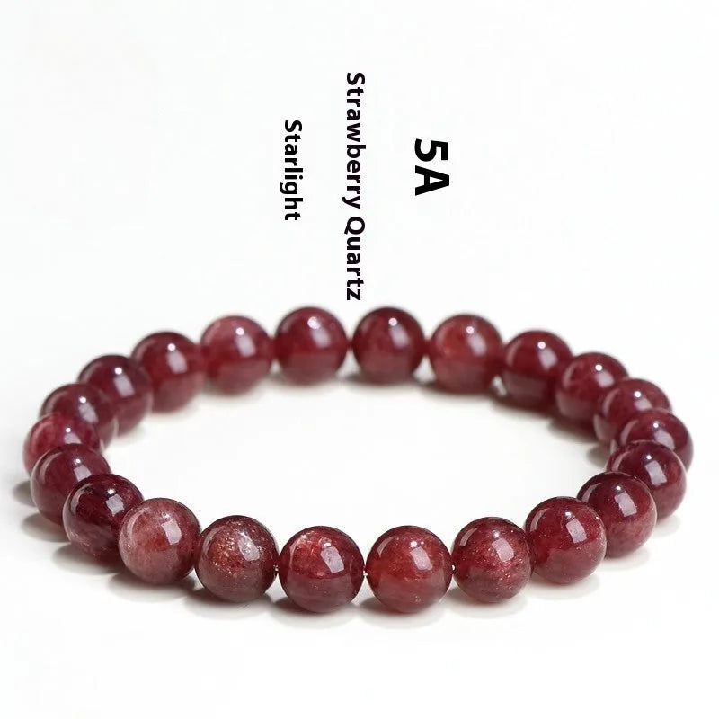 A strawberry quartz bracelet with geometrically cut, cherry red crystal beads on a black background.