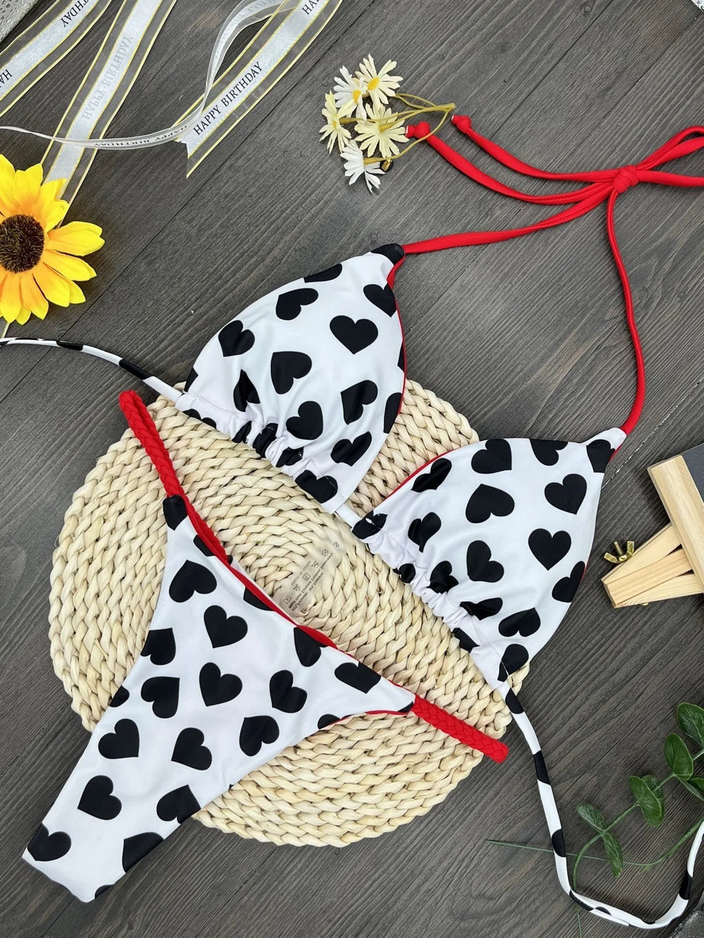Sexy solid-colour swimsuit with heart print, backless design, and split detail.