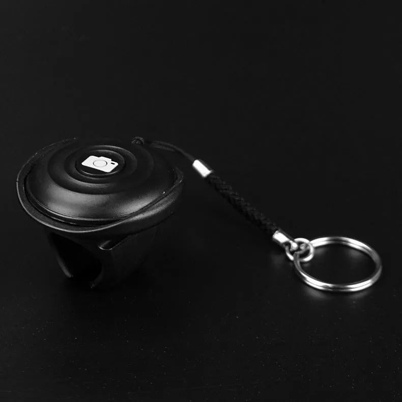 Black Bluetooth remote control for smartphone photography with snap button design