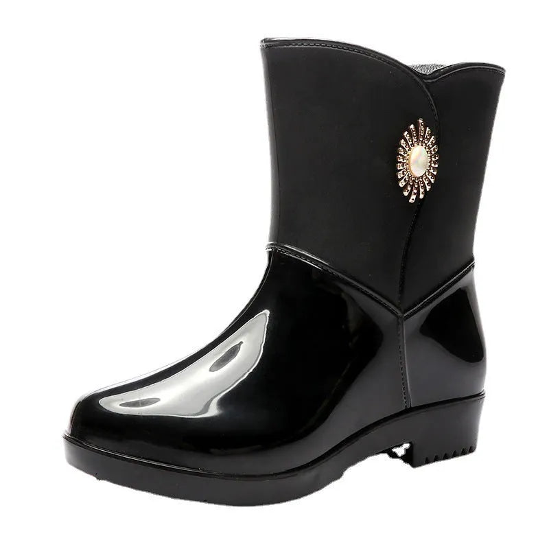 Women's purple PVC rain boot with non-slip sole and middle tube height.