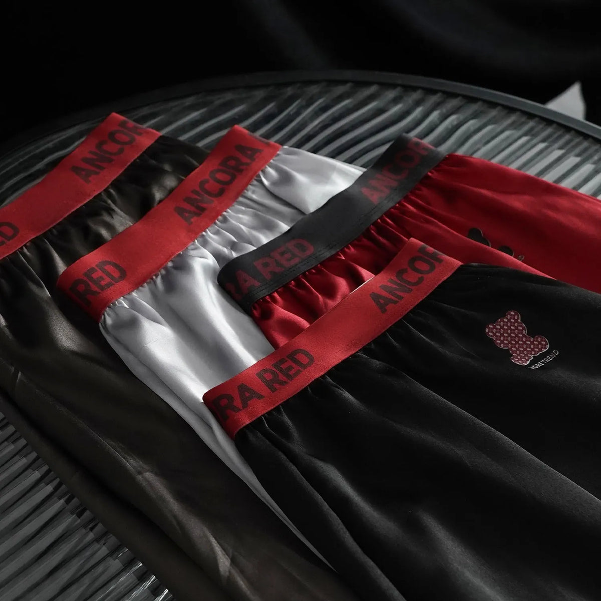 Solid colour men's boxer briefs in polyester knitting available in black, blue, red, silver, purple, brown