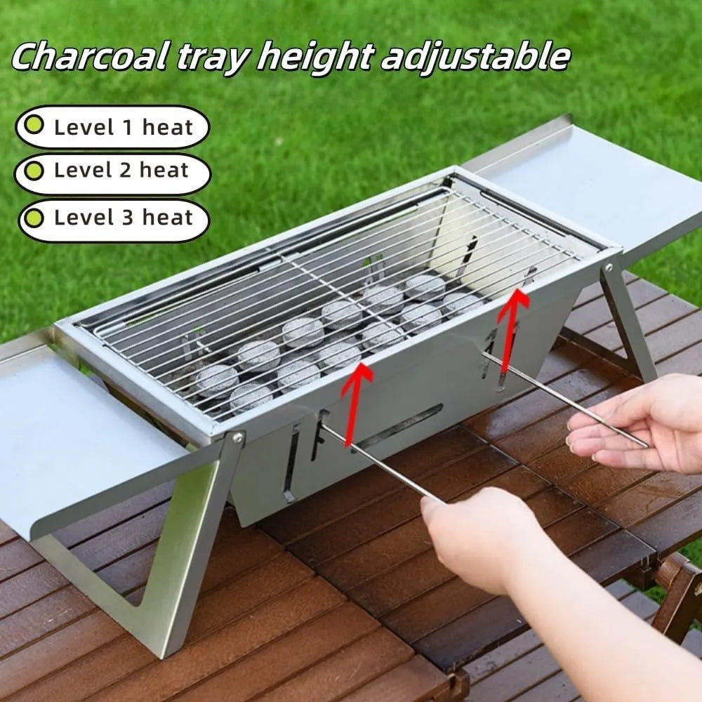 Small folding portable charcoal grill shown set up for an outdoor barbecue.